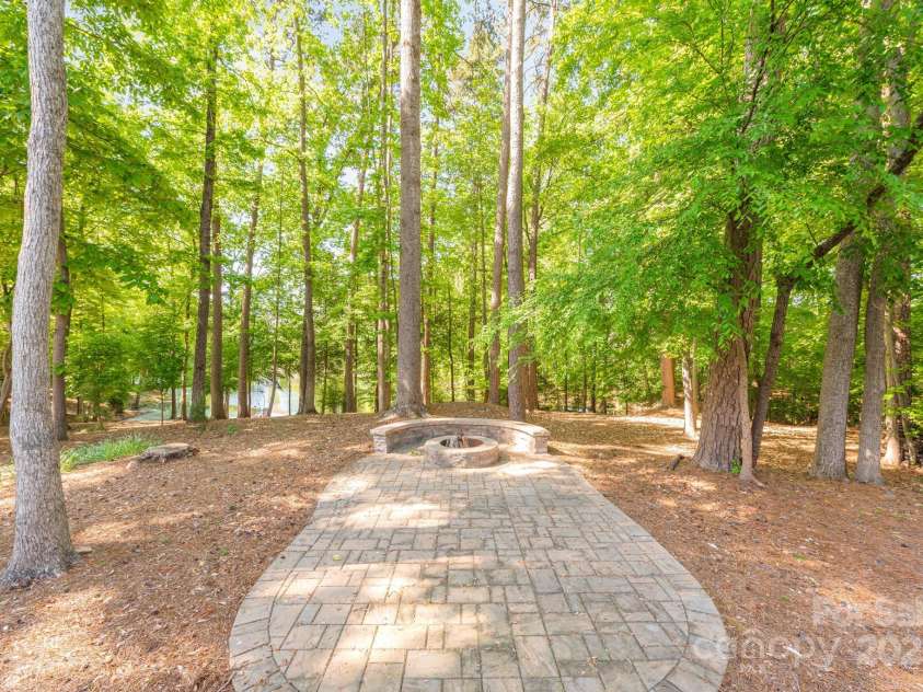 212 Seven Oaks Landing, Belmont, NC 28012.  MLS# CAR4253528, YatesRealty ID 9634. Your own fire pit on the edge of the pond