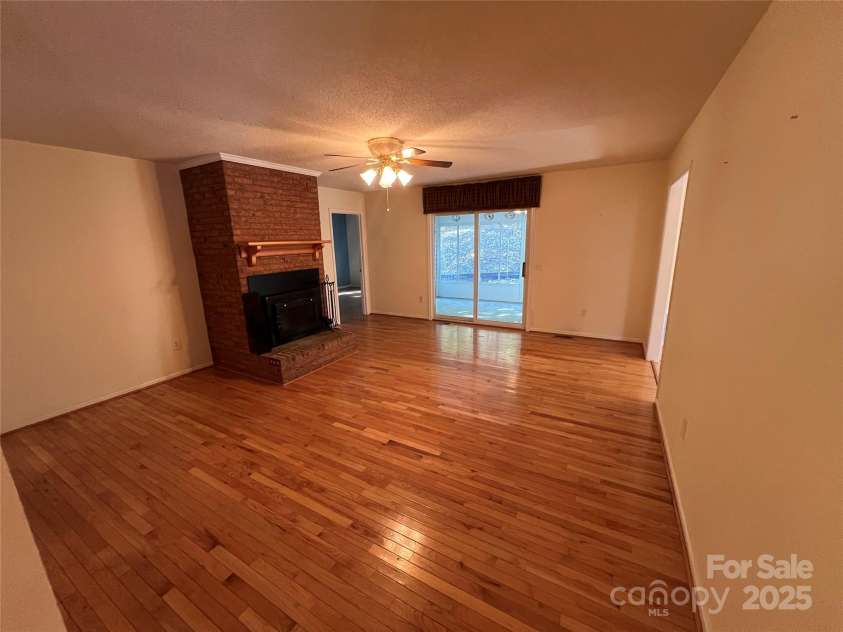 25397 Stony Mountain Road, Albemarle, NC 28001.  MLS# CAR4314846, YatesRealty ID 9653. Living Room with Fireplace Insert