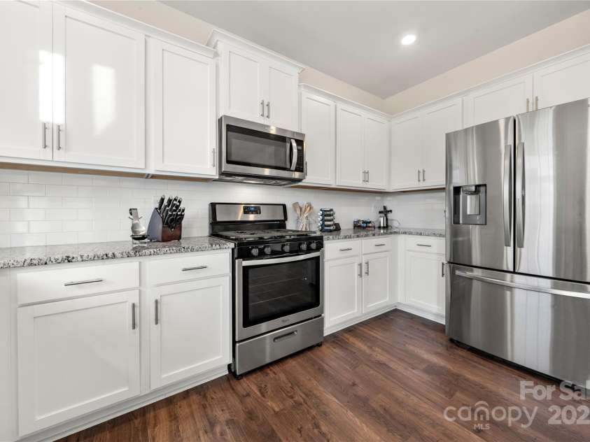 9706 Tea Garden Drive, Gastonia, NC 28056.  MLS# CAR4236017, YatesRealty ID 9657. Fresh white kitchen cabinets with gorgeous plank flooring