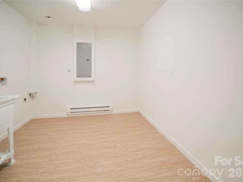 106 Shelly Drive, Hendersonville, NC 28792.  MLS# CAR4366479, YatesRealty ID 9675. Large laundry room with commode and sink