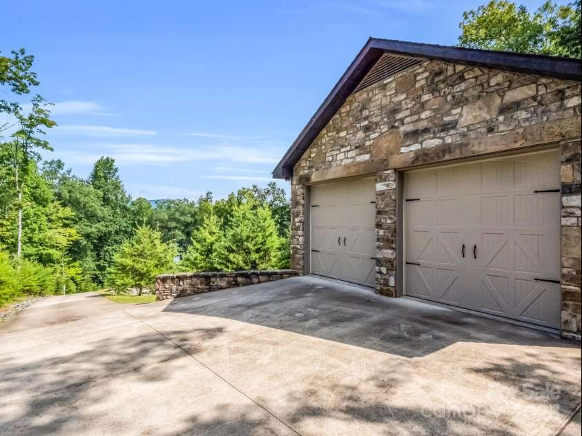 2452 Lake Adger Parkway, Mill Spring, NC 28756.  MLS# CAR4222407, YatesRealty ID 968. Two-car stone garage