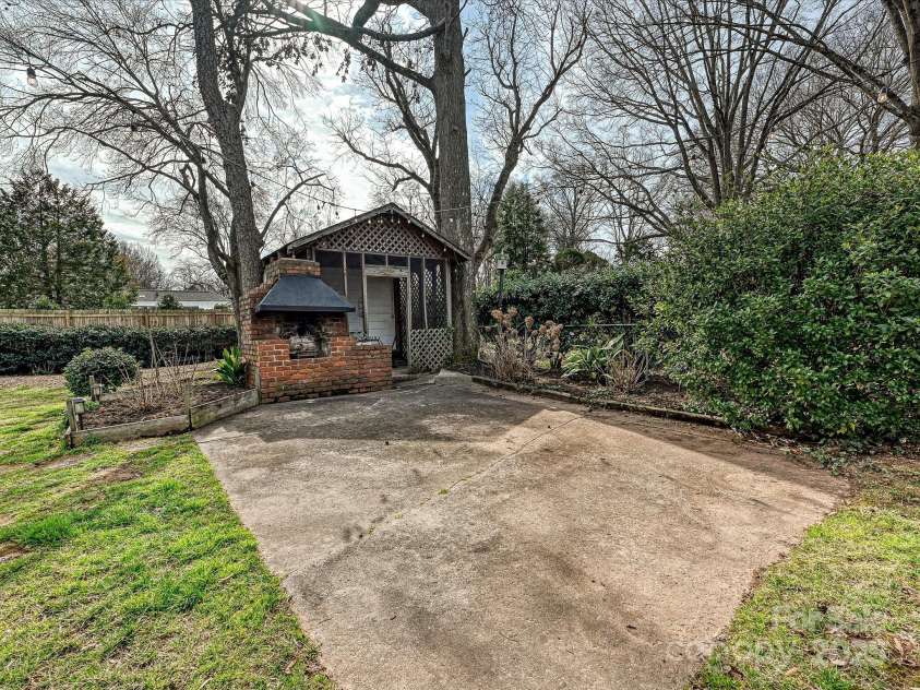 4132 Sulkirk Road, Charlotte, NC 28210.  MLS# CAR4223769, YatesRealty ID 9687. Backyard Patio with Fireplace and Covered Area
