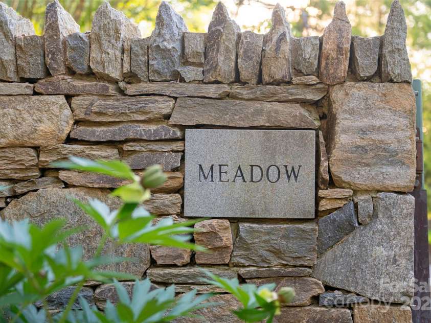 268 Holly Arbor Lane, Asheville, NC 28803.  MLS# CAR4268471, YatesRealty ID 97. Charming plaques adorn the stone walls throughout the estate, elegantly naming key features and adding a thoughtful, storybook touch to the property’s curated design.