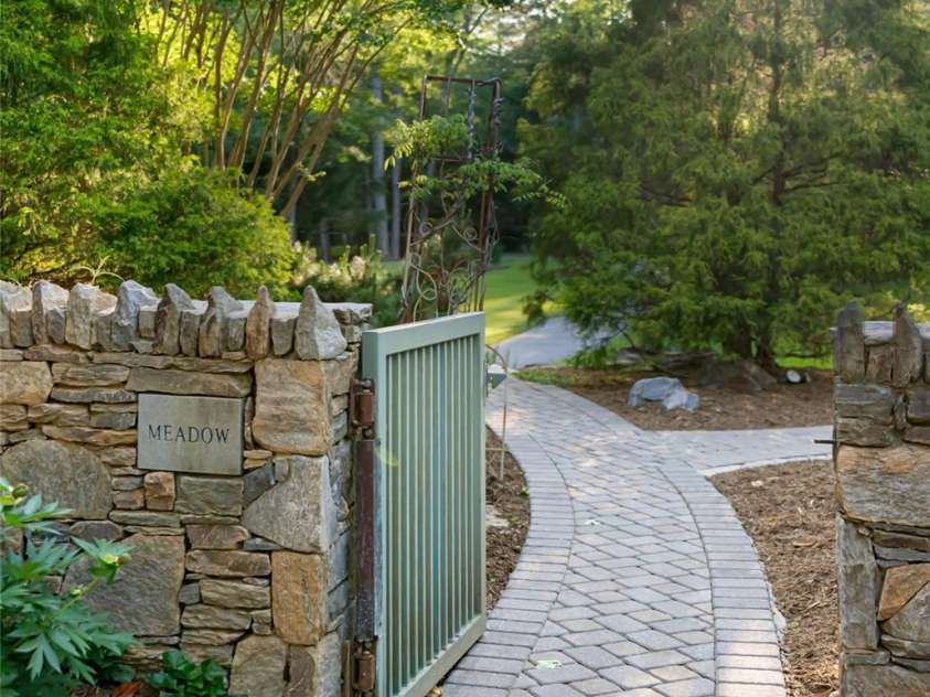 268 Holly Arbor Lane, Asheville, NC 28803.  MLS# CAR4268471, YatesRealty ID 97. Charming plaques adorn the stone walls throughout the estate, elegantly naming key features and adding a thoughtful, storybook touch to the property’s curated design.