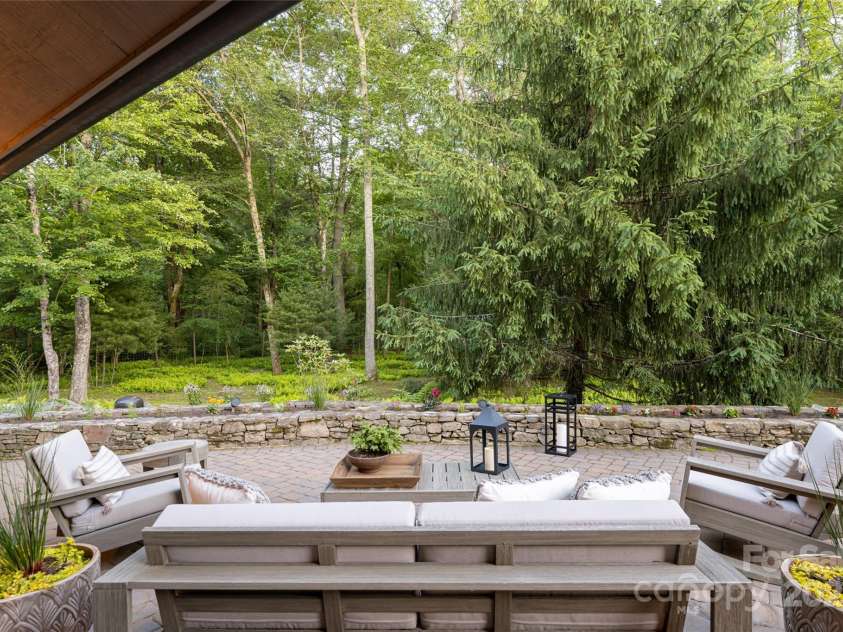 268 Holly Arbor Lane, Asheville, NC 28803.  MLS# CAR4268471, YatesRealty ID 97. Enjoy over 2,200 square feet of outdoor living in the main house—screened porches with fireplaces, serene patios for al fresco dining, and a fire-pit lounge outside the game room.