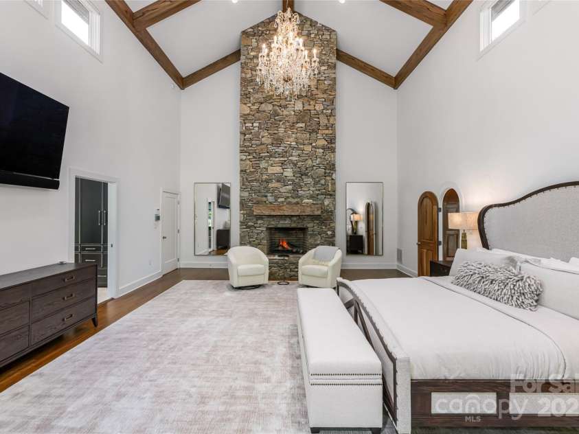 268 Holly Arbor Lane, Asheville, NC 28803.  MLS# CAR4268471, YatesRealty ID 97. Floor to ceiling stone gas fireplace in the primary bedroom.