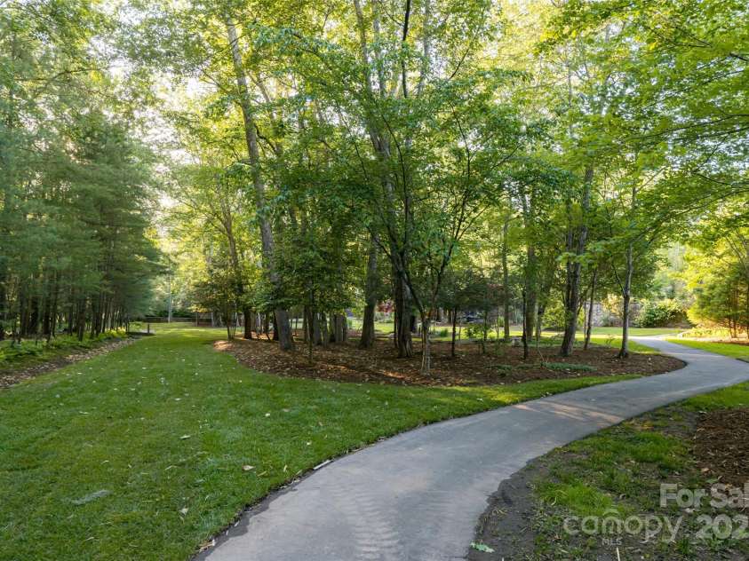 268 Holly Arbor Lane, Asheville, NC 28803.  MLS# CAR4268471, YatesRealty ID 97. He estate features paved paths that meander throughout the grounds and along the banks of Dingle Creek, creating your own private park—perfect for a peaceful afternoon stroll.