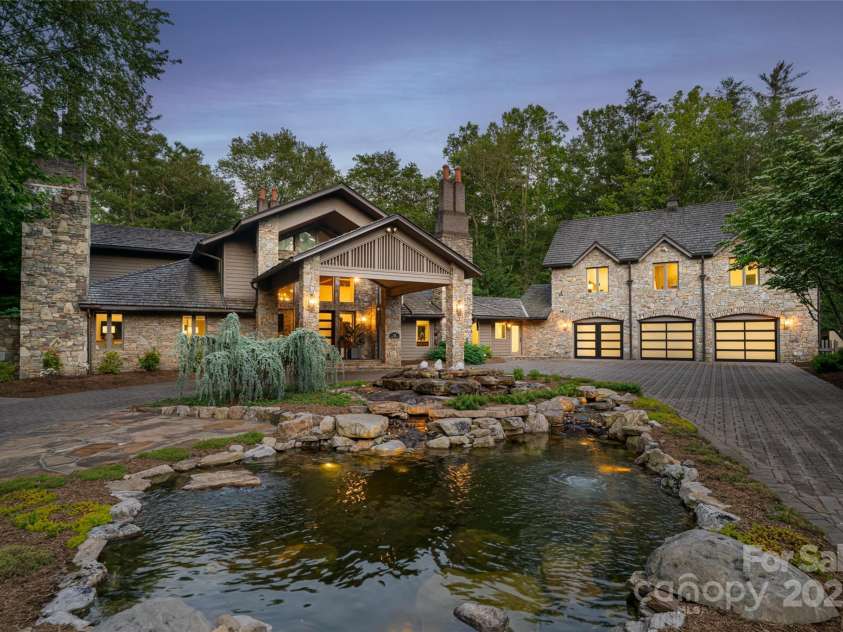 268 Holly Arbor Lane, Asheville, NC 28803.  MLS# CAR4268471, YatesRealty ID 97. Old-world stone elegance meets modern luxury in this gated, stately residence featuring a circular driveway, grand portico, and tranquil pond.  Main House features a 3 car garage.