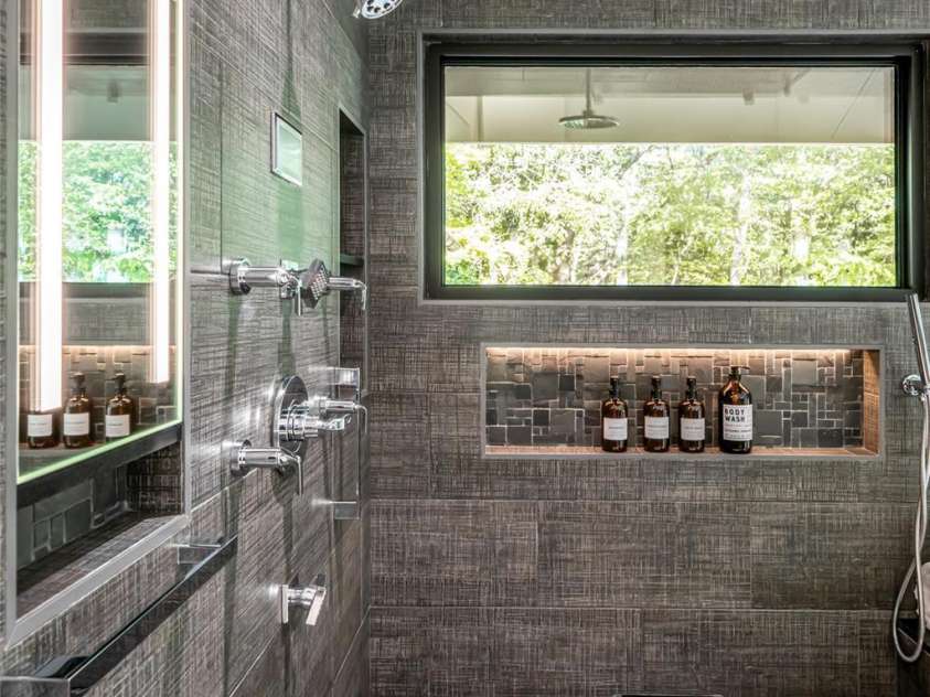 268 Holly Arbor Lane, Asheville, NC 28803.  MLS# CAR4268471, YatesRealty ID 97. Oversized glass shower equipped with a STEAMIST steam system and multiple Brizo shower fixture system.