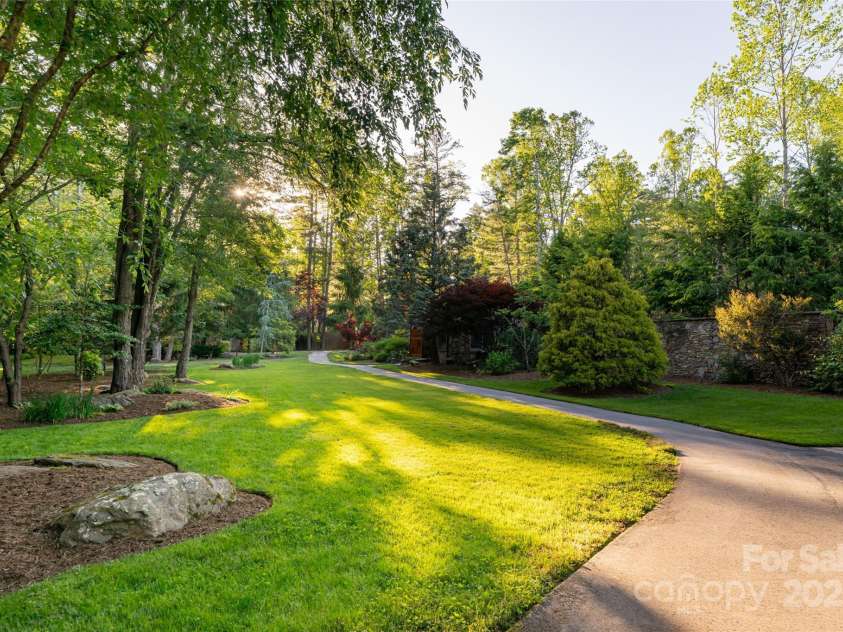 268 Holly Arbor Lane, Asheville, NC 28803.  MLS# CAR4268471, YatesRealty ID 97. The estate features paved paths that meander throughout the grounds and along the banks of Dingle Creek, creating your own private park—perfect for a peaceful afternoon stroll.