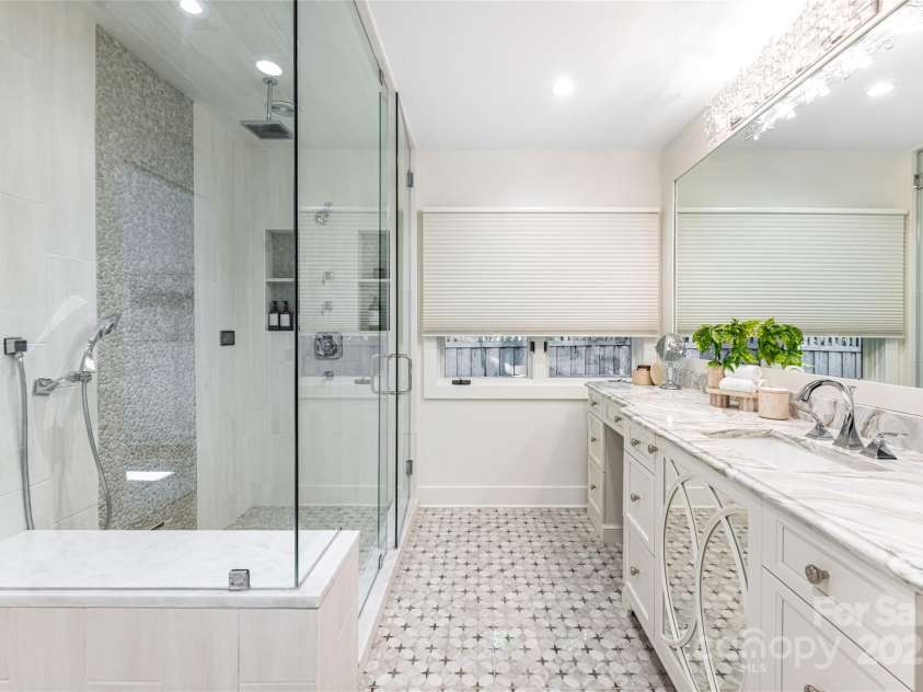 268 Holly Arbor Lane, Asheville, NC 28803.  MLS# CAR4268471, YatesRealty ID 97. The main level guest suites feature a luxury en-suite bath featuring a glass shower equipped with a STEAMIST steam system.