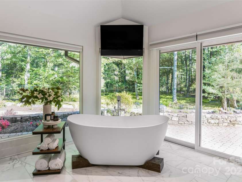 268 Holly Arbor Lane, Asheville, NC 28803.  MLS# CAR4268471, YatesRealty ID 97. The soaking tub is surrounded by forest views.