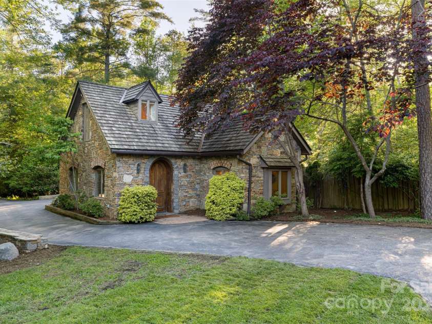 268 Holly Arbor Lane, Asheville, NC 28803.  MLS# CAR4268471, YatesRealty ID 97. The Stone Gate House is a charming one-bedroom guest cottage with a private entrance and one-car garage, offering a comfortable and secluded retreat for your guests.