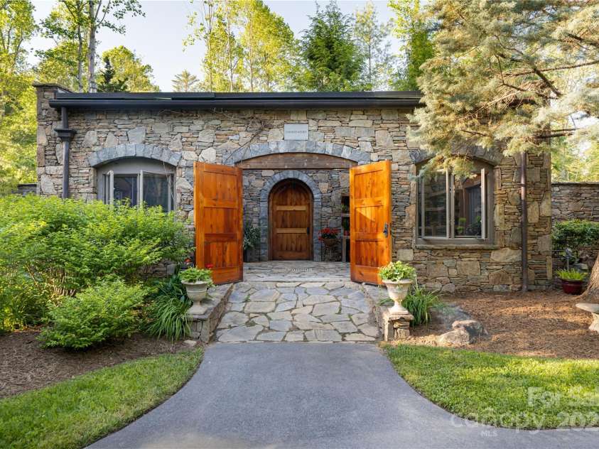 268 Holly Arbor Lane, Asheville, NC 28803.  MLS# CAR4268471, YatesRealty ID 97. The storybook stone conservancy, steeped in old-world charm, is a cherished retreat nestled among vibrant gardens and overlooking a tranquil meadow.
