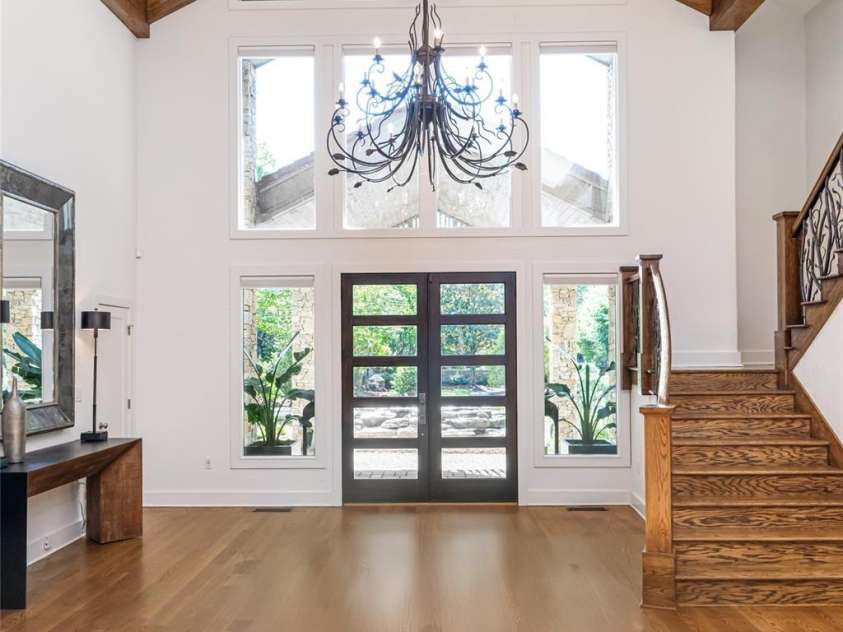 268 Holly Arbor Lane, Asheville, NC 28803.  MLS# CAR4268471, YatesRealty ID 97. Upon entering the main house, a striking post and beam ceiling pairs beautifully with modern front doors, creating a timeless and luxurious entryway accented by refined rustic details.