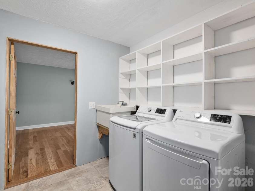 6 Star Berry Lane, Fairview, NC 28730.  MLS# CAR4315024, YatesRealty ID 9705. Convenient Main Level Laundry Room With Sink & Built In Storage