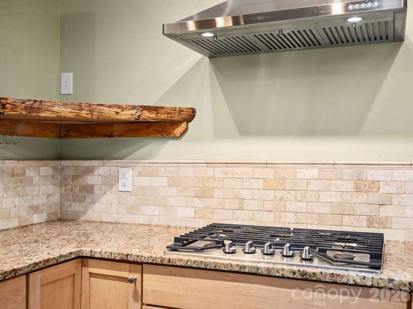 6 Star Berry Lane, Fairview, NC 28730.  MLS# CAR4315024, YatesRealty ID 9705. Gas Range, Built-In Custom Shelving, And Ceramic Tile Backsplash