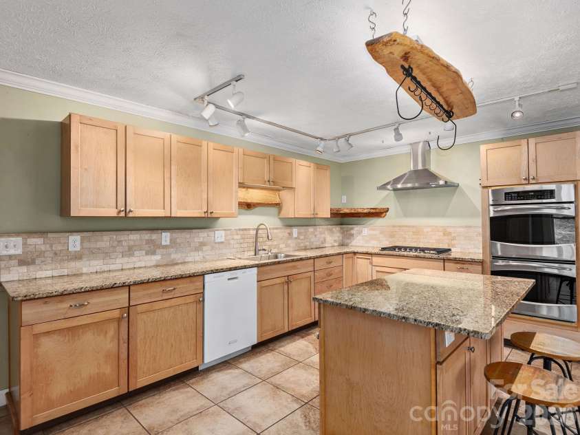 6 Star Berry Lane, Fairview, NC 28730.  MLS# CAR4315024, YatesRealty ID 9705. Spacious Custom Cabinets, Breakfast Bar & Island, and Convenient Breakfast Bar Complete this Chef's Kitchen