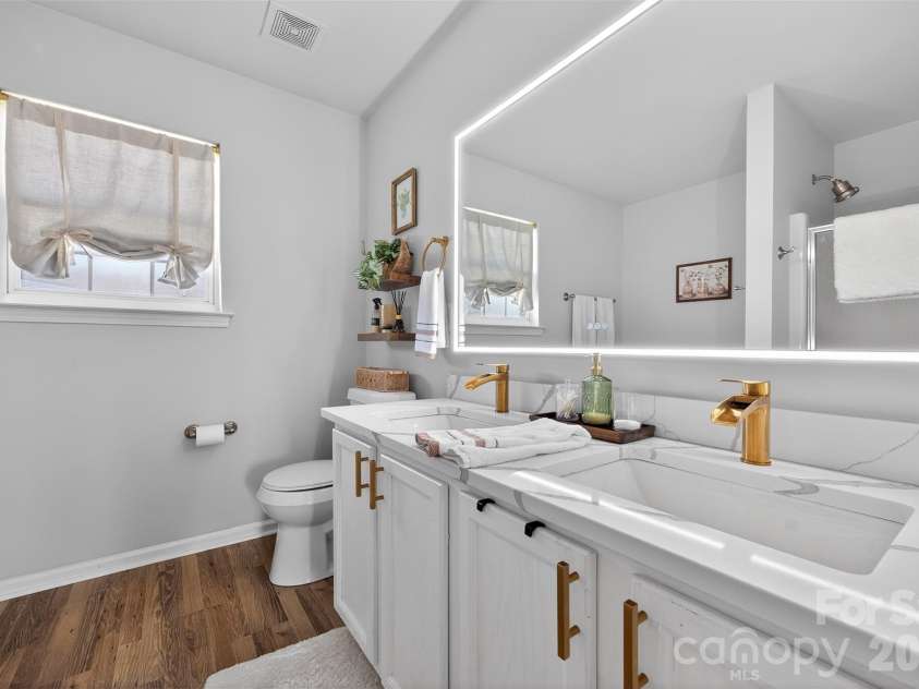 11028 Grapeyard Court, Charlotte, NC 28273.  MLS# CAR4360855, YatesRealty ID 9707. Primary bathroom has been updated with lighted mirror, quartz counters