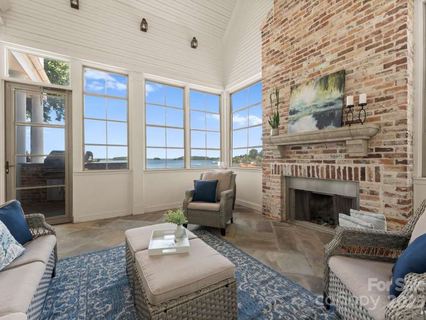 16921 Jetton Road, Cornelius, NC 28031.  MLS# CAR4191237, YatesRealty ID 971. Screened porch with fireplace and lake views adjacent to kitchen