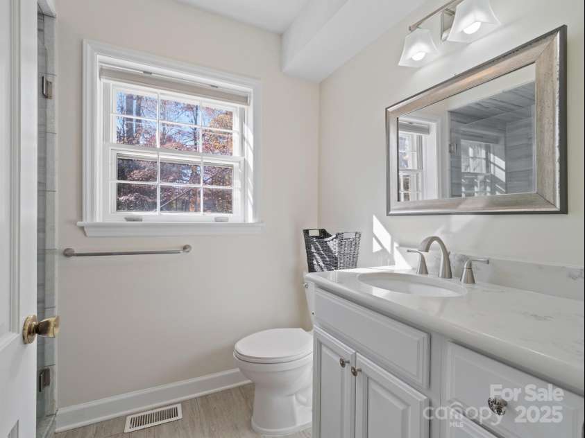 2111 Sagamore Road, Charlotte, NC 28209.  MLS# CAR4323130, YatesRealty ID 973. Lower level renovated full bathroom with custom tile walk in shower