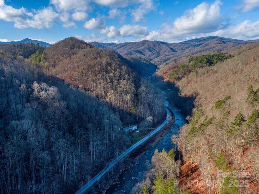 12982 US Hwy 19W None, Burnsville, NC 28714.  MLS# CAR4234088, YatesRealty ID 975. Drone shot of house surrounded by 62 acres of Appalachian Mountains!