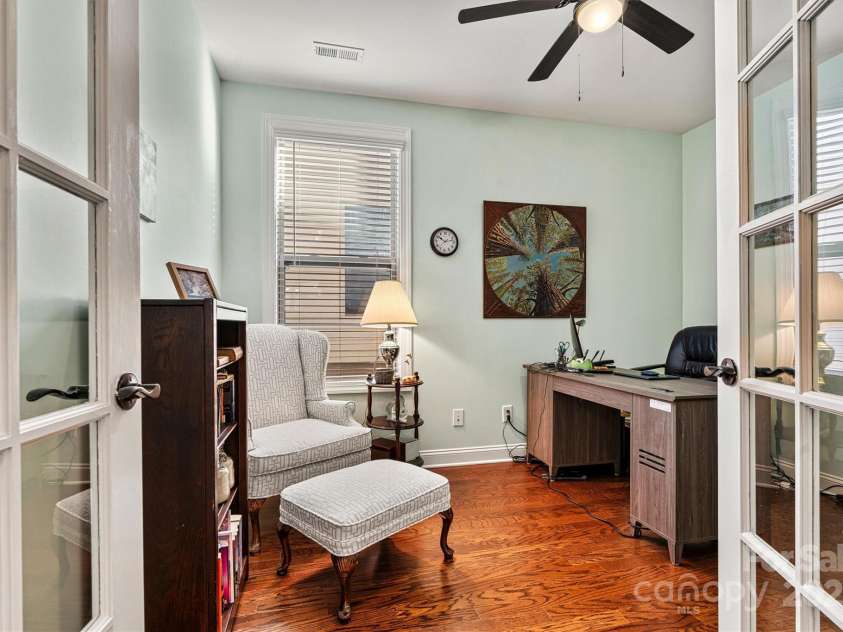 7029 Overjoyed Crossing, Charlotte, NC 28215.  MLS# CAR4212396, YatesRealty ID 9751. The Flex/Office has glistening hardwood floors, ceiling fan and glass french doors making this the perfect space for a 