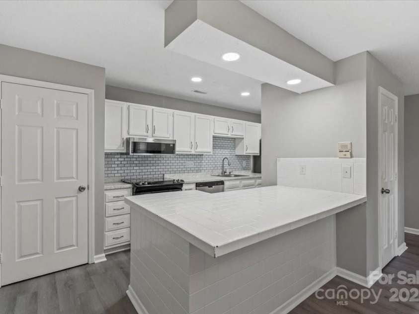 6224 Rosecroft Drive, Charlotte, NC 28215.  MLS# CAR4239650, YatesRealty ID 9757. Kitchen island with canister lighting and like new appliances.