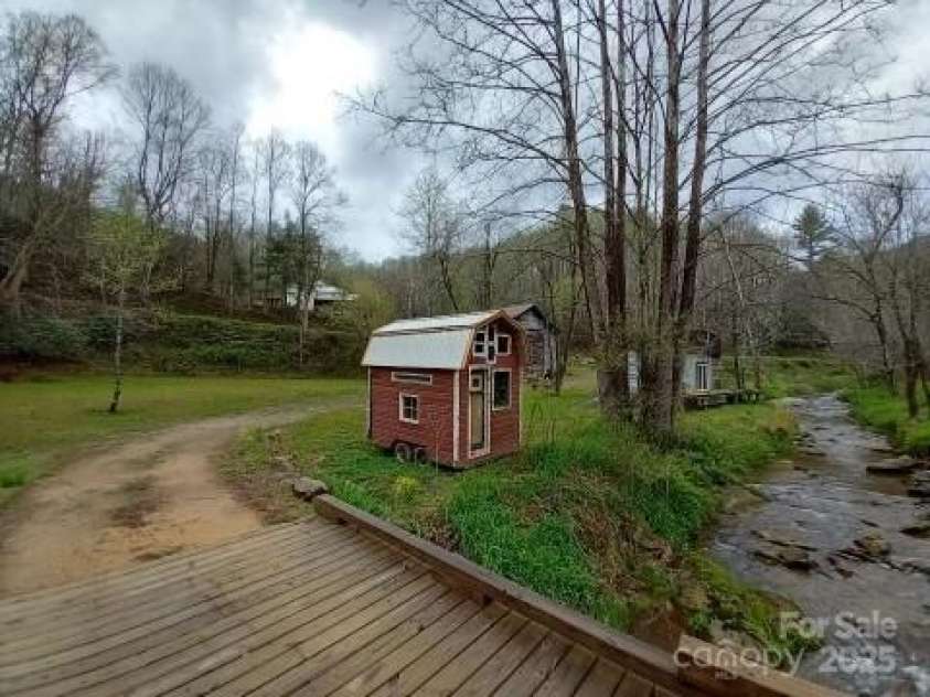 23 Katies Road, Marshall, NC 28753.  MLS# CAR4203088, YatesRealty ID 976. Seller Picture of pasture bridge and creek