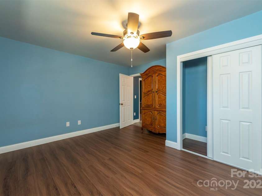 1740 Haywood Road, Hendersonville, NC 28791.  MLS# CAR4226897, YatesRealty ID 977. Bedroom with private access to the bonus room, ideal for couples or families traveling together, offering ample space, privacy, and comfort.