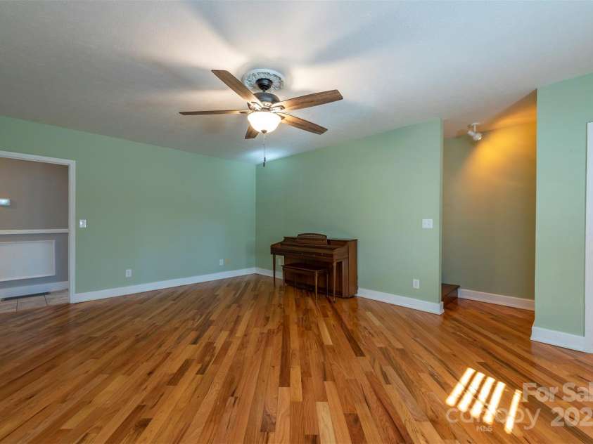 1740 Haywood Road, Hendersonville, NC 28791.  MLS# CAR4226897, YatesRealty ID 977. Cozy family room, creating an intimate gathering space perfect for all occupants to relax.