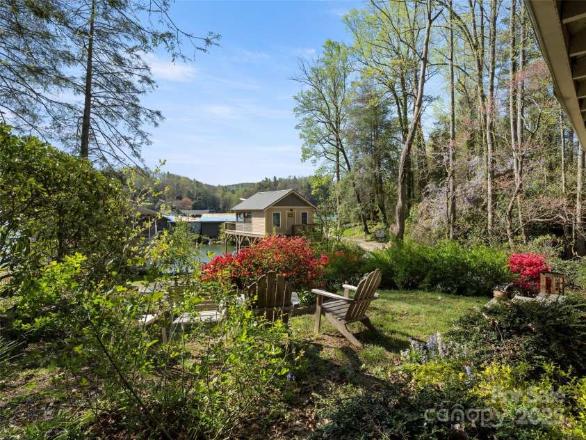 250 Mondamin Road, Zirconia, NC 28790.  MLS# CAR4248567, YatesRealty ID 9771. View front front yard looking at boathouse