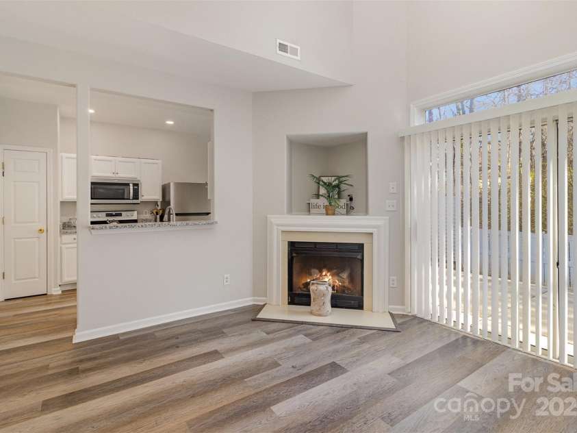 1751 Holliford Court, Charlotte, NC 28215.  MLS# CAR4227714, YatesRealty ID 9772. Great Room with Gas Fireplace turned on