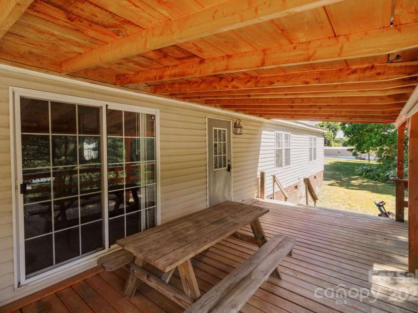 145 McCreek Drive, China Grove, NC 28023.  MLS# CAR4252985, YatesRealty ID 9777. Beautiful covered deck