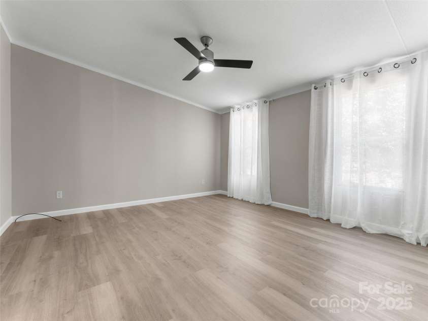 25 Overbrook Drive, Saluda, NC 28773.  MLS# CAR4306681, YatesRealty ID 981. Large primary bedroom with the entire end of the house as a private suite. 