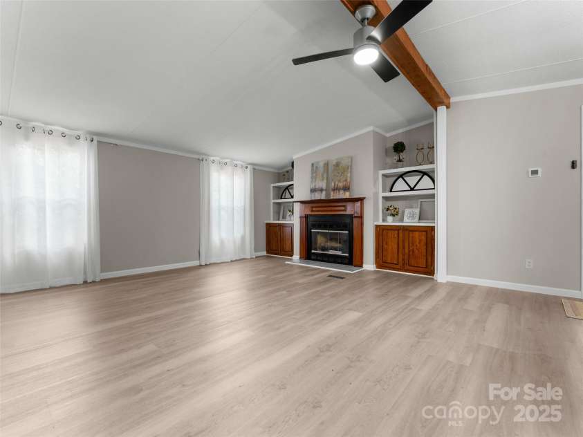 25 Overbrook Drive, Saluda, NC 28773.  MLS# CAR4306681, YatesRealty ID 981. Open family room area features high peak ceiling and lots of natural light. 