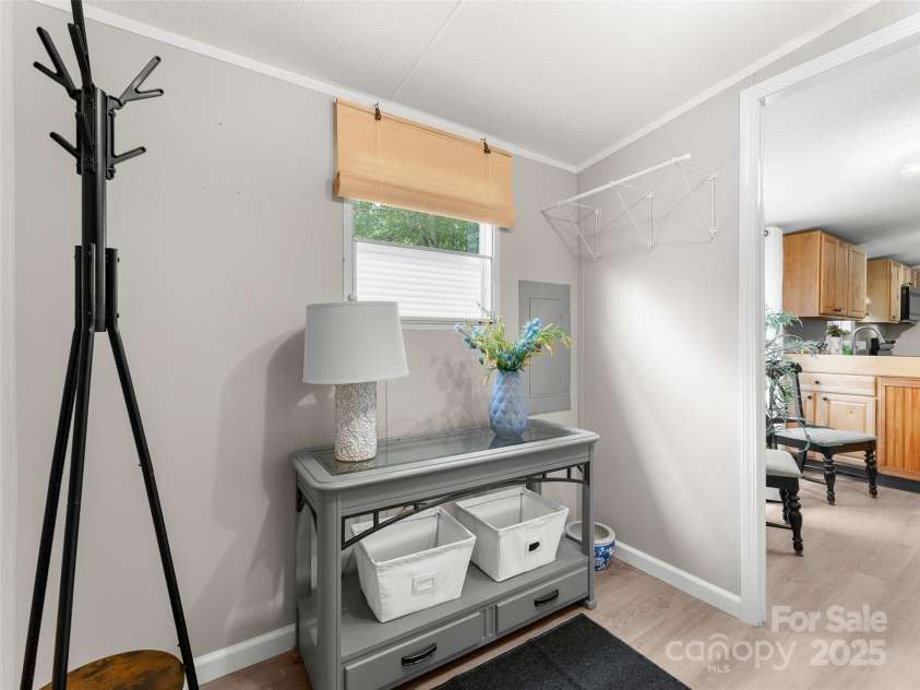 25 Overbrook Drive, Saluda, NC 28773.  MLS# CAR4306681, YatesRealty ID 981. Other side of laundry room/ mud room/ side entrance. Space for folding table, shoe/ coat storage and lots more. 