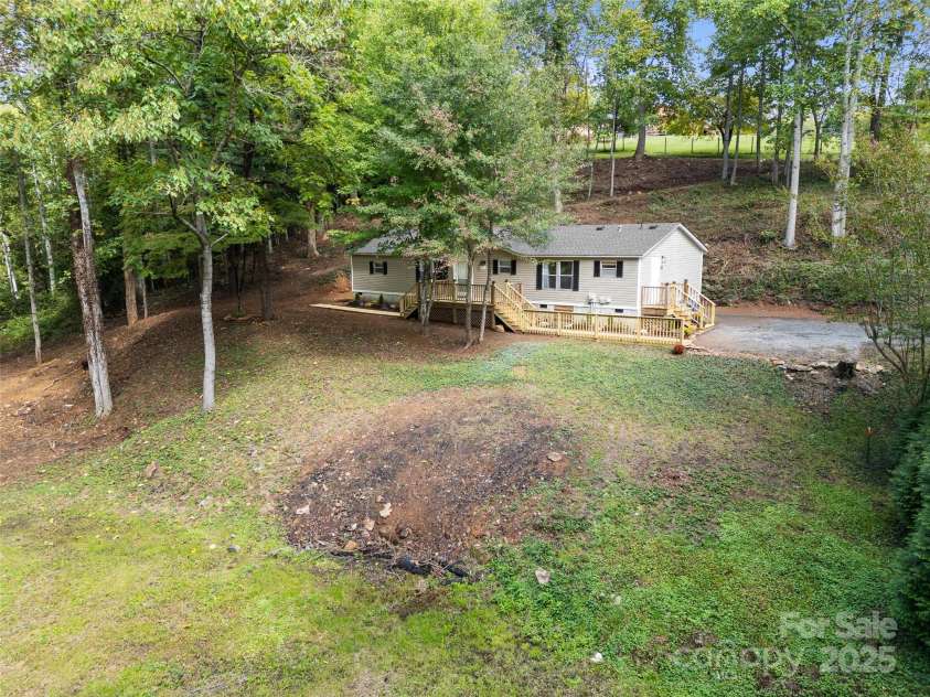 25 Overbrook Drive, Saluda, NC 28773.  MLS# CAR4306681, YatesRealty ID 981. Recently cleared yard offers sunny side for gardening and trees for shade and woodland nature areas. Enjoy the best of both in this lovely natural lot. 