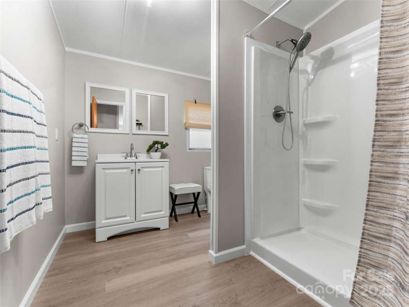 25 Overbrook Drive, Saluda, NC 28773.  MLS# CAR4306681, YatesRealty ID 981. Second bathroom also has convenient step in shower and deluxe shower head. 