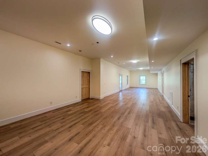 338 Majestic Mountain Drive, Burnsville, NC 28714.  MLS# CAR4277521, YatesRealty ID 981. Fully Finished Downstairs offers flexible spacious room that would be ideal for Media, Recreation & More! Includes Outdoor Access, Under the Stairs Storage, Spacious Bedroom with private en-suite bathroom & More