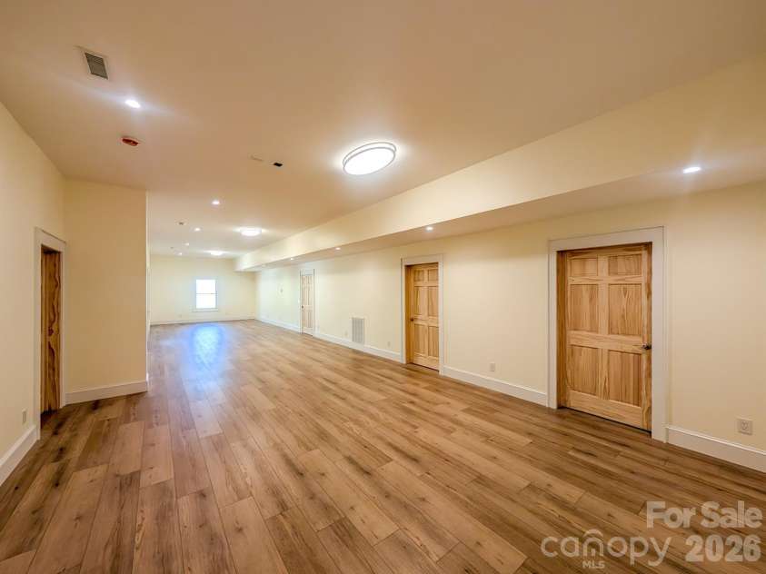 338 Majestic Mountain Drive, Burnsville, NC 28714.  MLS# CAR4277521, YatesRealty ID 981. Fully Finished Downstairs offers flexible spacious room that would be ideal for Media, Recreation & More! Includes Outdoor Access, Under the Stairs Storage, Spacious Bedroom with private en-suite bathroom & More