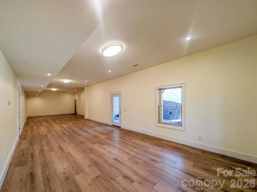 338 Majestic Mountain Drive, Burnsville, NC 28714.  MLS# CAR4277521, YatesRealty ID 981. Fully Finished Downstairs offers flexible spacious room that would be ideal for Media, Recreation & More! Includes Outdoor Access, Under the Stairs Storage, Spacious Bedroom with private en-suite bathroom & More