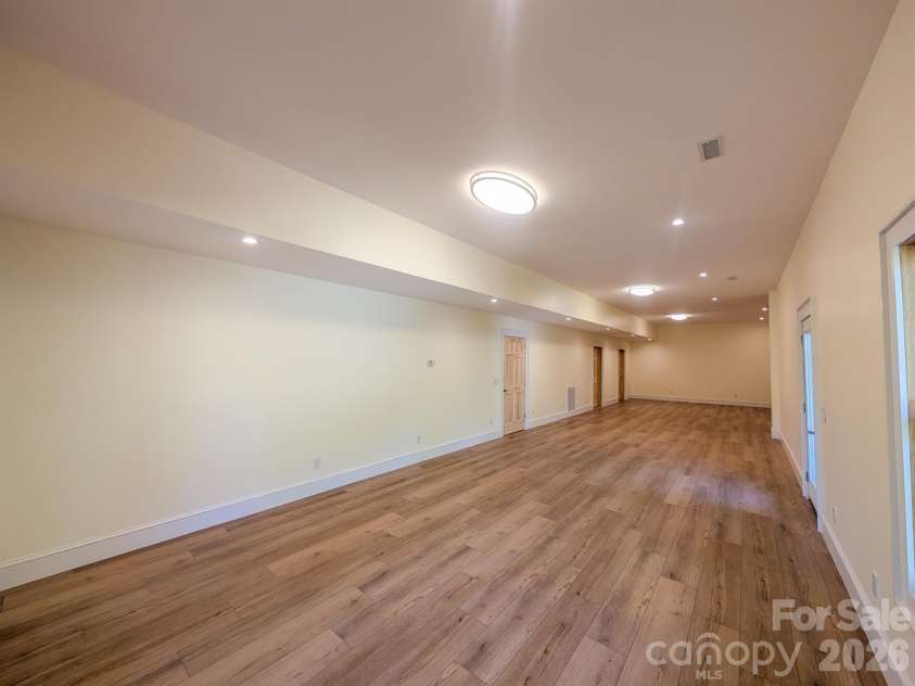 338 Majestic Mountain Drive, Burnsville, NC 28714.  MLS# CAR4277521, YatesRealty ID 981. Fully Finished Downstairs offers flexible spacious room that would be ideal for Media, Recreation & More! Includes Outdoor Access, Under the Stairs Storage, Spacious Bedroom with private en-suite bathroom & More