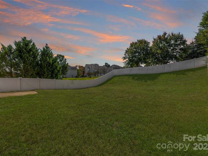 6934 Tanners Creek Drive, Huntersville, NC 28078.  MLS# CAR4303299, YatesRealty ID 9819. Rear yard with full vinyl privacy fence