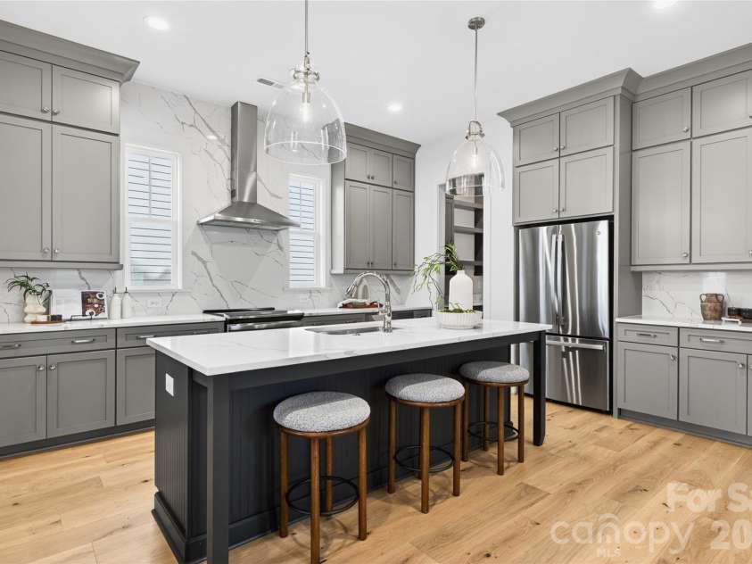 7245 Westrow Avenue, Charlotte, NC 28278.  MLS# CAR4314661, YatesRealty ID 982. Gourmet kitchen with large center island, quartz countertops and modern vent hood. This gathering space is perfect for entertaining.