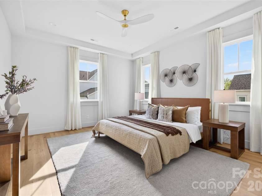 7245 Westrow Avenue, Charlotte, NC 28278.  MLS# CAR4314661, YatesRealty ID 982. Spacious primary suite on the lower level with tray ceiling. Added recessed lighting and windows fill the room with natural light. A perfect space to unwind at the end of the day.