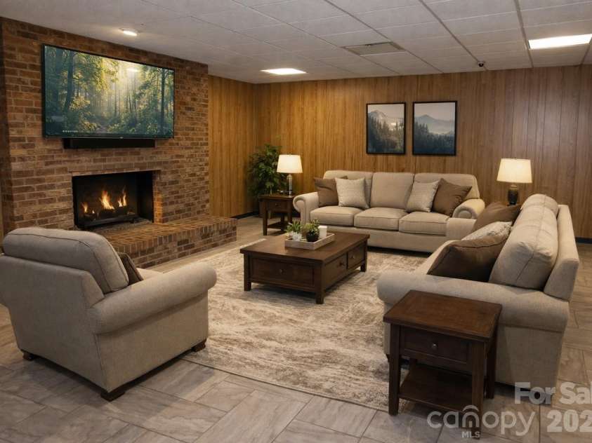 682 Cecil Street, Thomasville, NC 27360.  MLS# CAR4411361, YatesRealty ID 9827. Basement den with fireplace