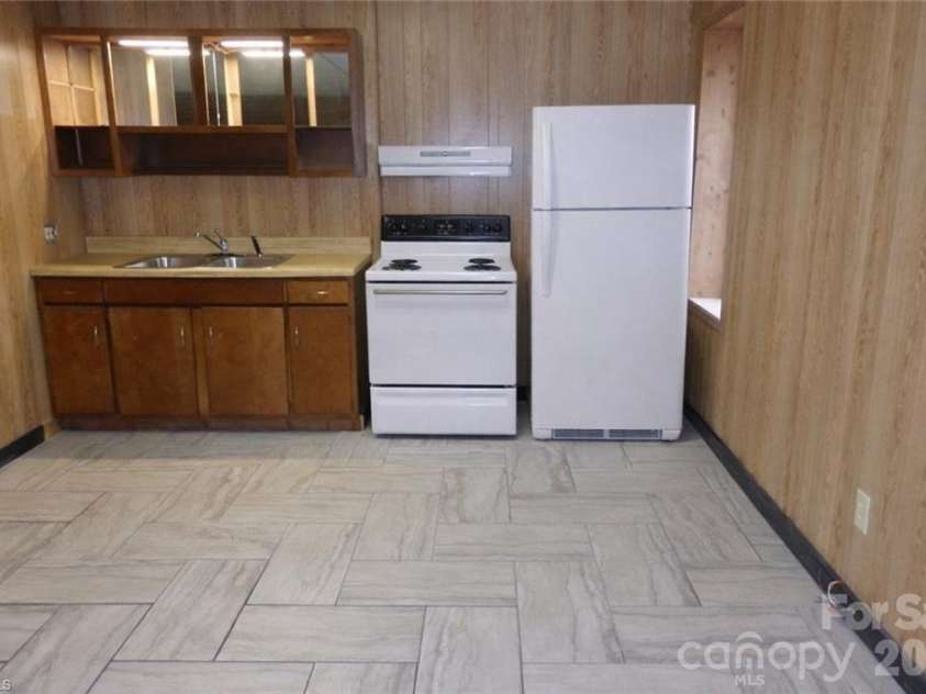 682 Cecil Street, Thomasville, NC 27360.  MLS# CAR4411361, YatesRealty ID 9827. Basement kitchenette. Stove and refrigerator virtually staged