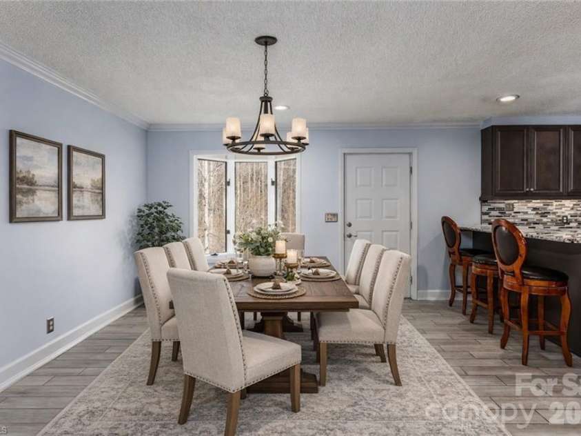 682 Cecil Street, Thomasville, NC 27360.  MLS# CAR4411361, YatesRealty ID 9827. Dining area with door to back deck. Virtually staged