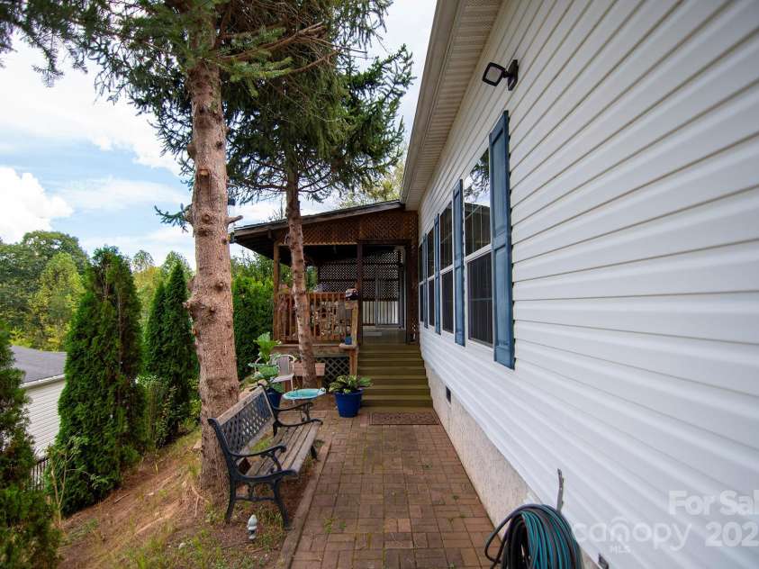 304 Golden Aster Road, Swannanoa, NC 28778.  MLS# CAR4304564, YatesRealty ID 985. Side View and Front Entrance to house
